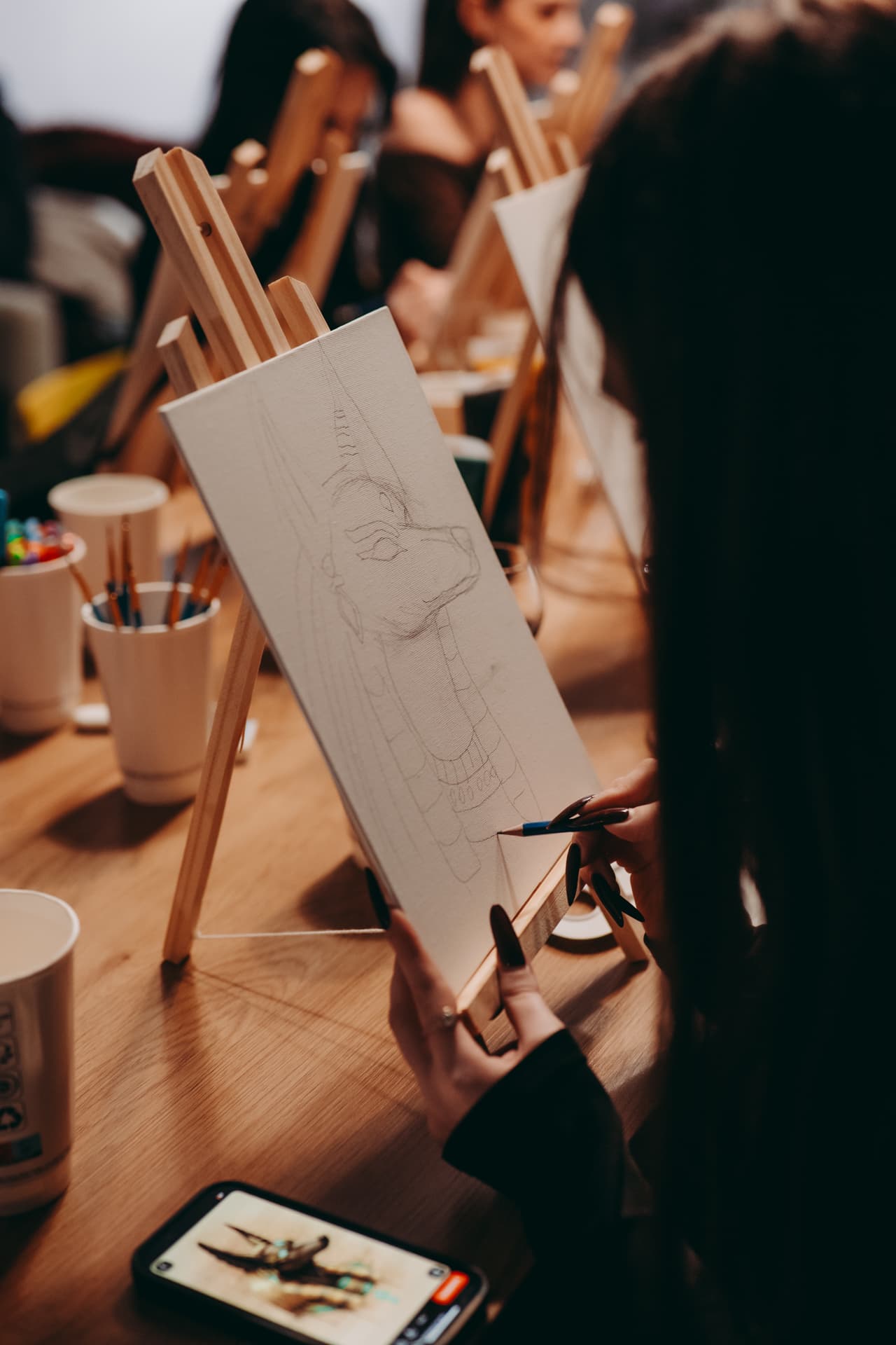 Sketching the jackal portrait outline on the canvas