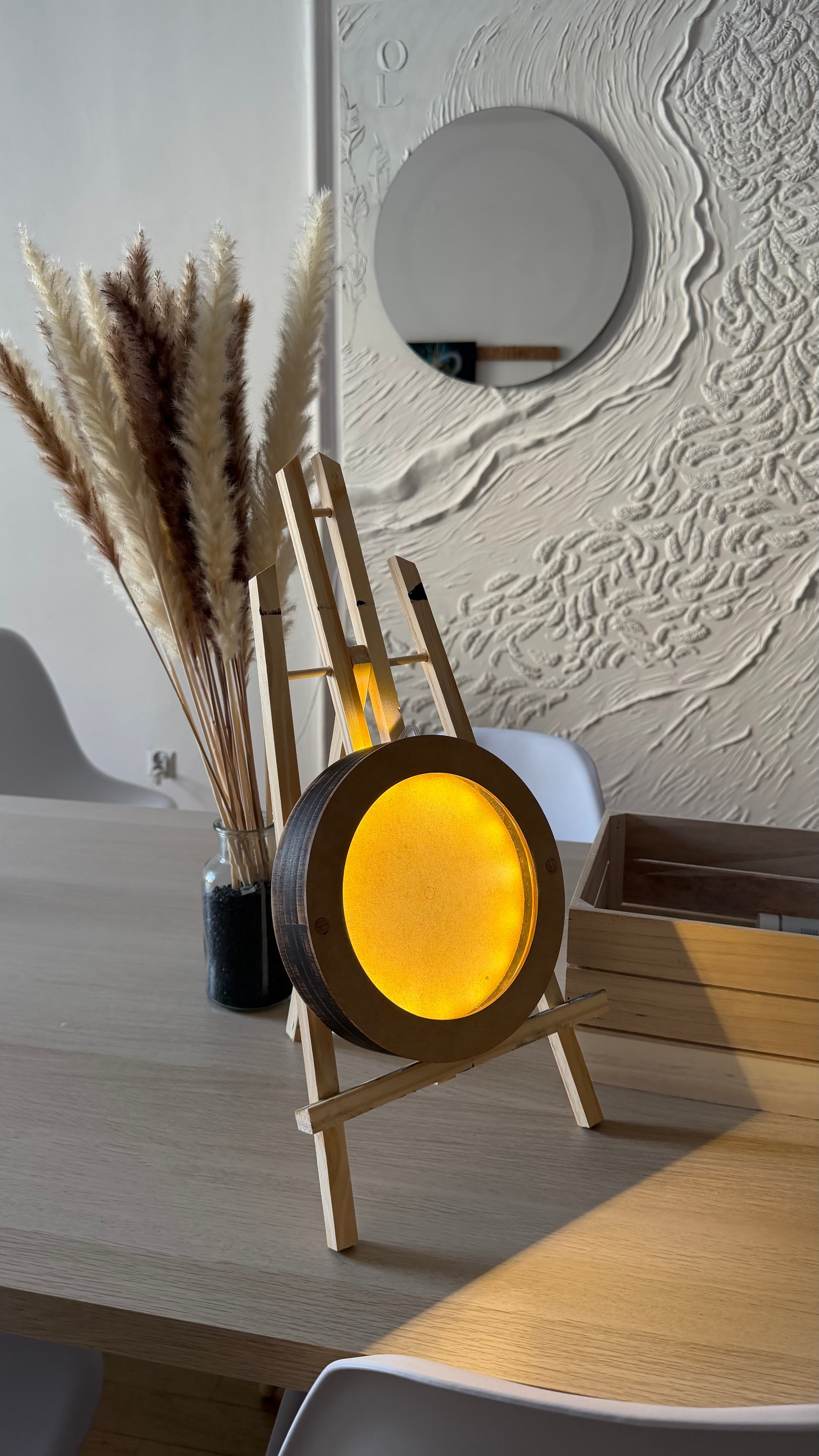 LED moon art board displayed on an easel in the studio